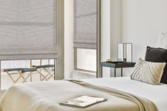 Interior of spacious bedroom with cozy bed and bedside table